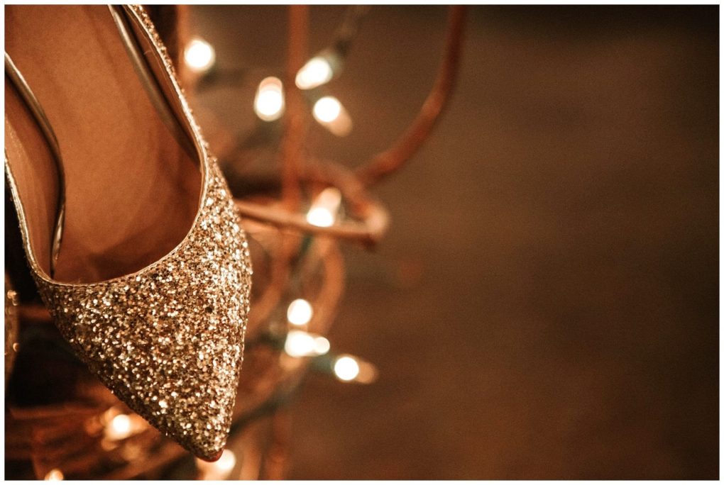 Premier snohomish & seattle wedding photographer | gsquared weddings photography a close up of a sparkly gold high heeled shoe with pointed toe surrounded by warm glowing string lights in a softly blurred backgroundperfect for a magical snohomish seattle wedding or engagement | serving snohomish seattle                   & beyond