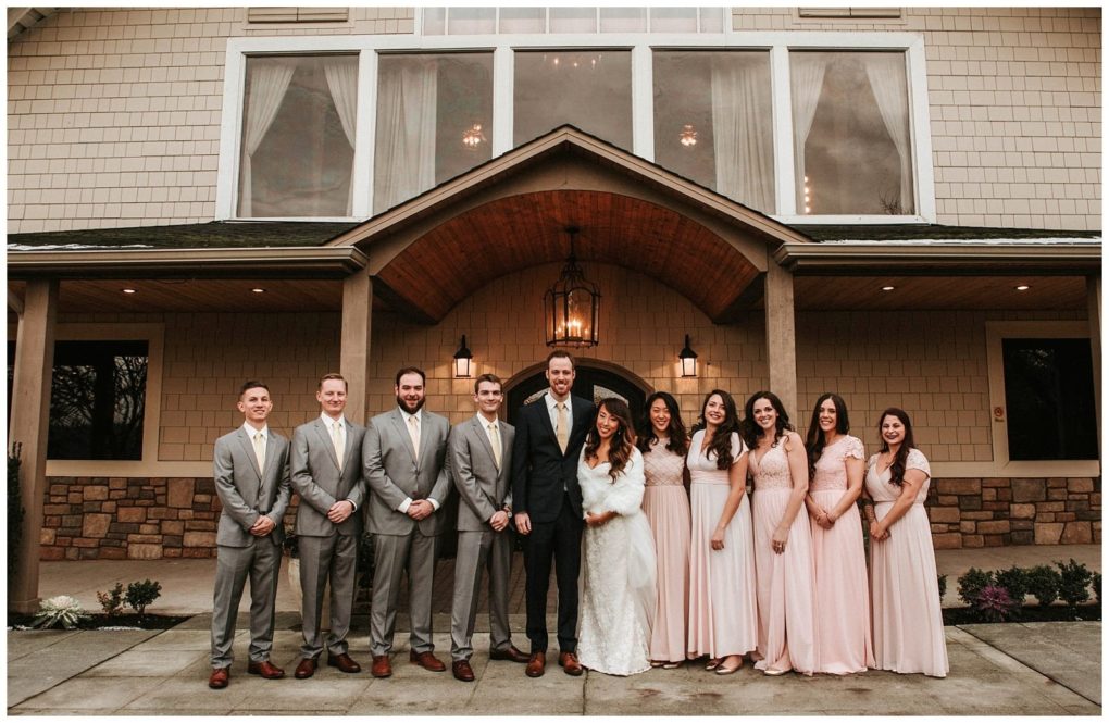 Premier snohomish & seattle wedding photographer | gsquared weddings photography a wedding party poses outside a snohomish building The bride and groom are in the center with bridesmaids in blush dresses and groomsmen in grey suits all smilinga joyful moment from a seattle wedding engagement | serving snohomish seattle                   & beyond