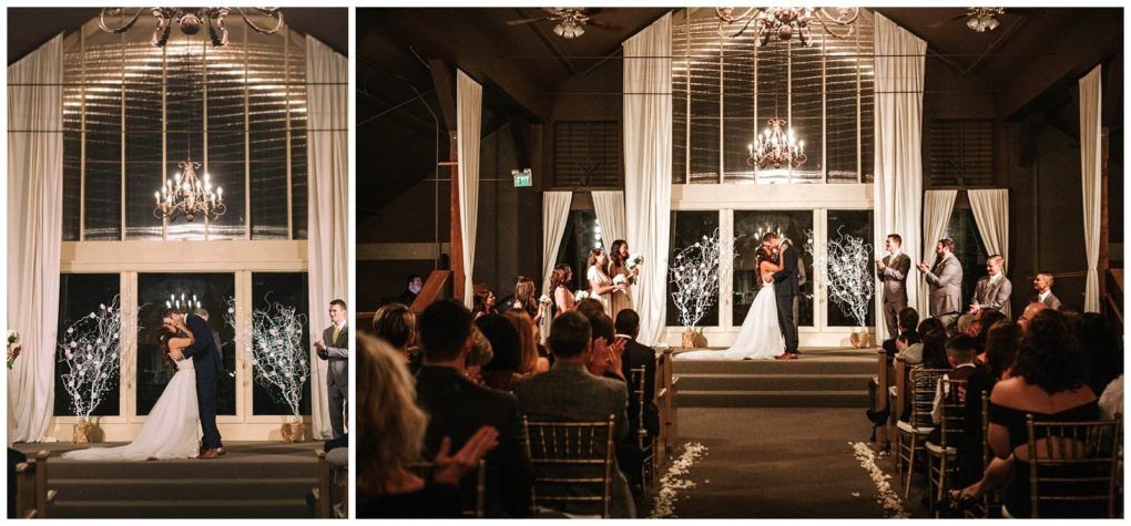 Premier snohomish & seattle wedding photographer | gsquared weddings photography a bride and groom share their first kiss as a married couple on an indoor stage at a snohomish seattle wedding surrounded by their wedding party and applauded by guests under warm elegant lighting | serving snohomish seattle                   & beyond