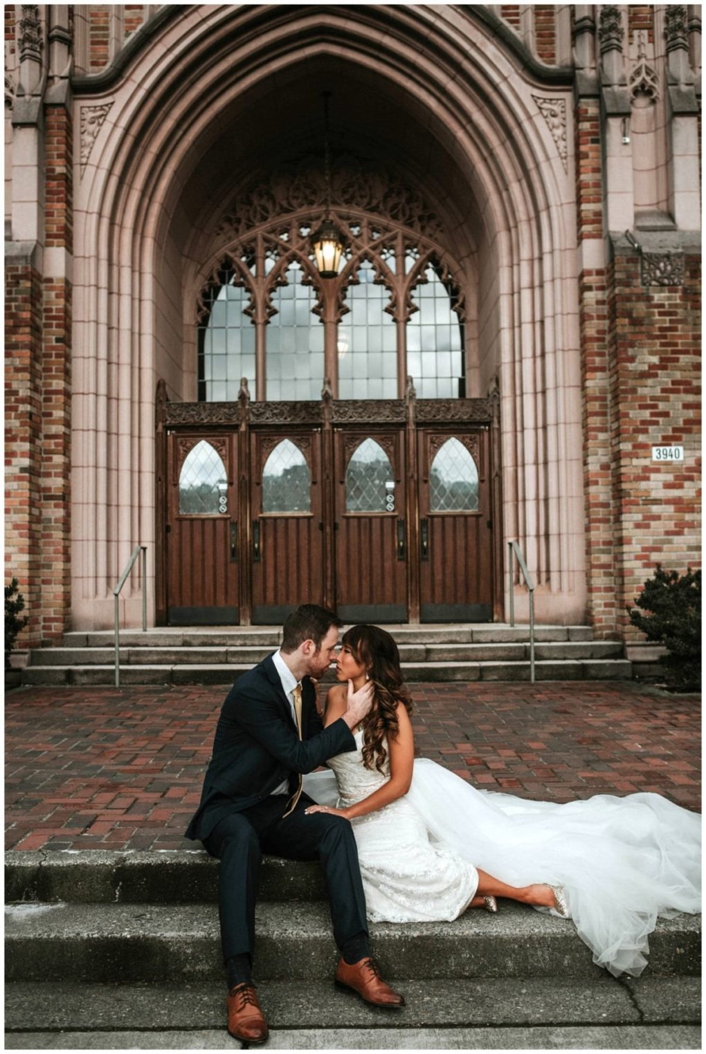 Premier snohomish & seattle wedding photographer | gsquared weddings photography a bride and groom sit on stone steps in front of a grand arched church entrance in snohomish lovingly embracing and gazing into each others eyes on their seattle wedding day | serving snohomish seattle                   & beyond