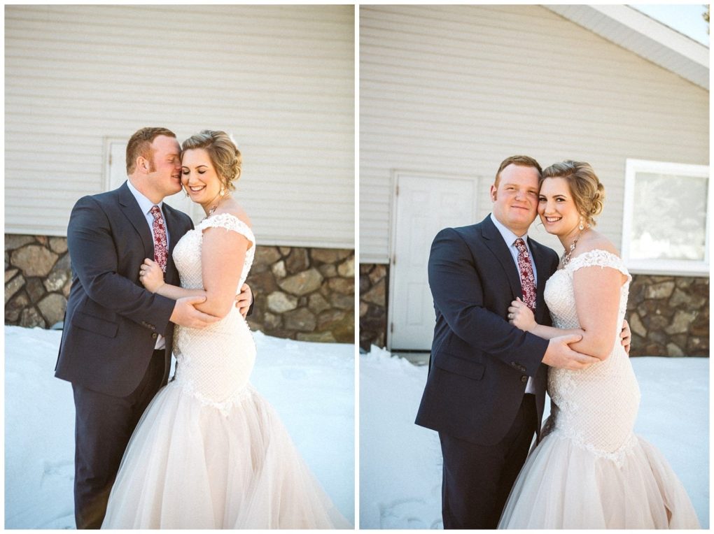 Premier snohomish & seattle wedding photographer | gsquared weddings photography a bride and groom in formal wedding attire embrace and smile outdoors in the snow standing in front of a stone sided building with white wallscapturing a magical snohomish seattle wedding moment | serving snohomish seattle                   & beyond