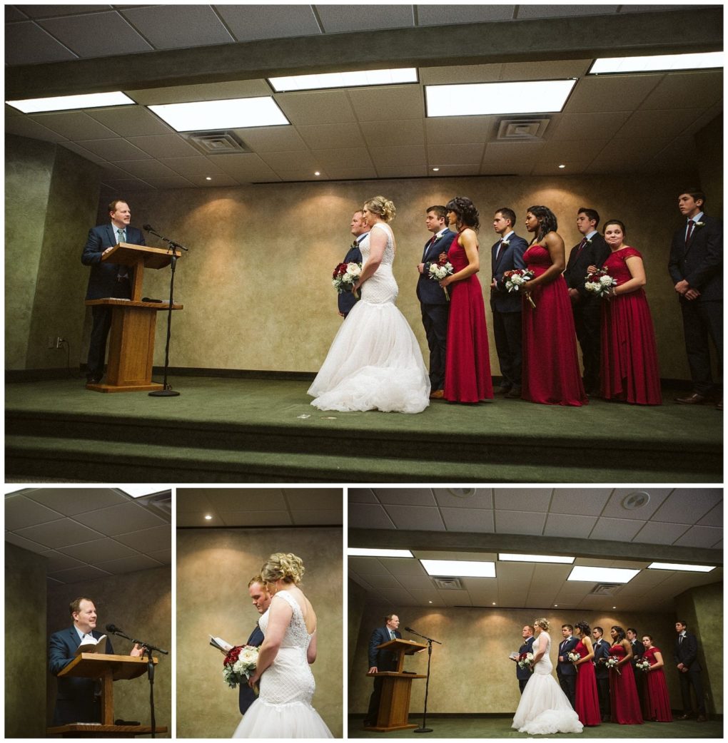Premier snohomish & seattle wedding photographer | gsquared weddings photography a bride and groom stand facing each other at a snohomish wedding ceremony flanked by bridesmaids in red dresses and groomsmen in suits while an officiant speaks from a podium | serving snohomish seattle                   & beyond