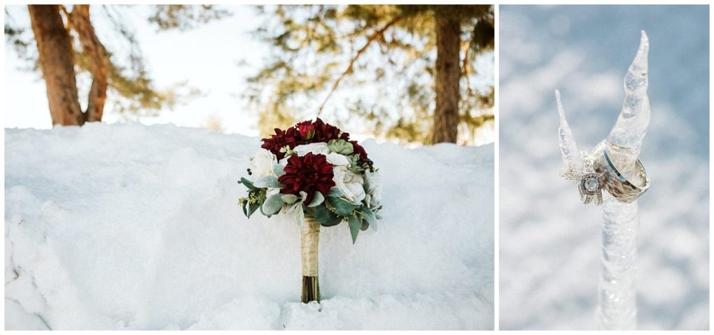 Premier snohomish & seattle wedding photographer | gsquared weddings photography a bouquet of red and white flowers rests on snow Beside it a set of wedding rings is displayed on the tip of a clear icicle with snowy trees in the backgroundcapturing a magical snohomish seattle wedding engagement | serving snohomish seattle                   & beyond