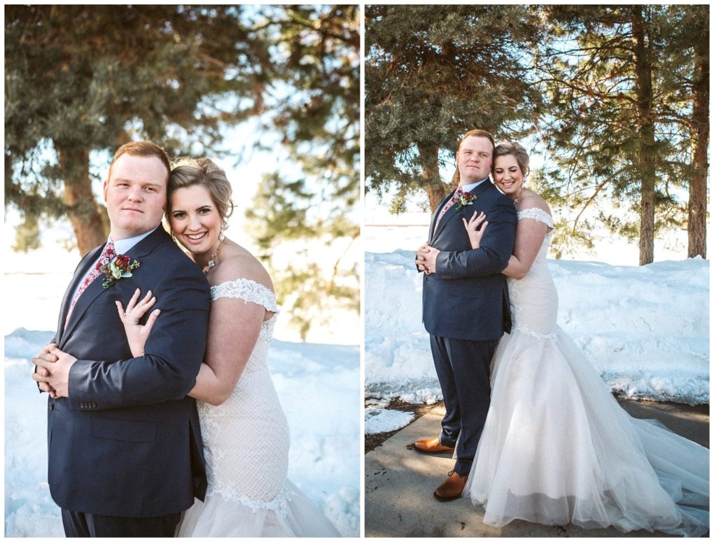 Premier snohomish & seattle wedding photographer | gsquared weddings photography a bride and groom stand outdoors in the snow near snohomish embracing and smiling for wedding photos The bride wears an off shoulder white gown the groom wears a navy suit Pine trees and snowbanks set a stunning seattle wedding scene | serving snohomish seattle                   & beyond