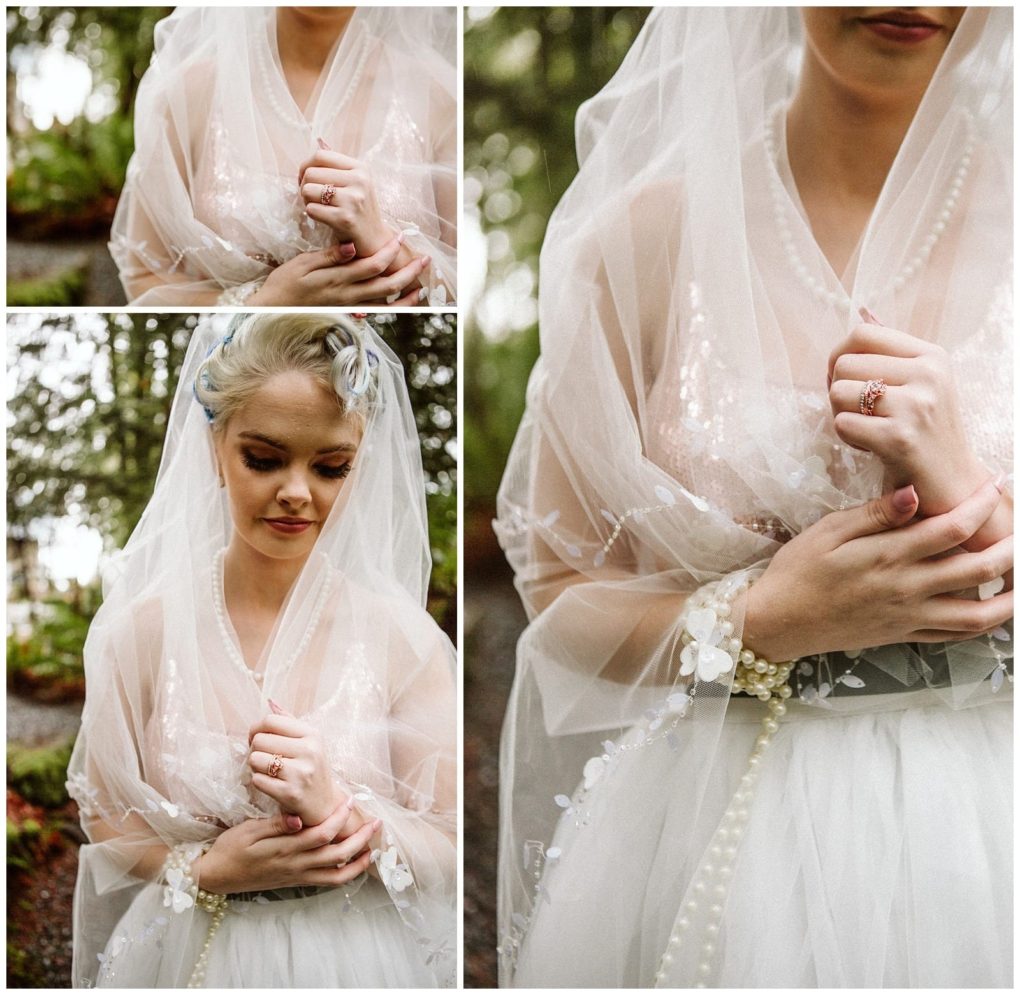 Premier snohomish & seattle wedding photographer | gsquared weddings photography a bride in a sheer beaded veil and white gown stands outdoors at a snohomish seattle wedding gently holding her veil and showing a delicate ring She has light hair styled softly and a serene thoughtful expression | serving snohomish seattle                   & beyond