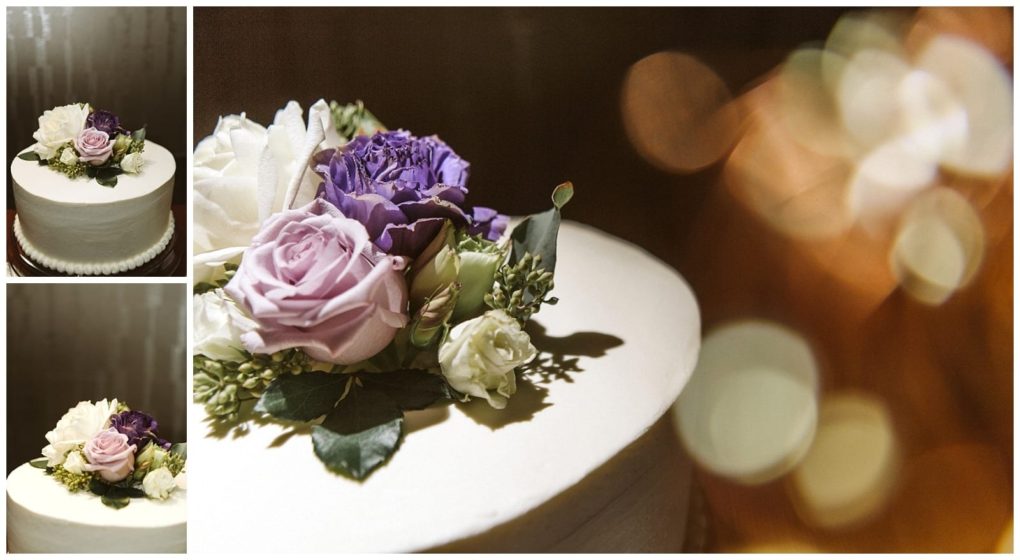 Premier snohomish & seattle wedding photographer | gsquared weddings photography a white frosted cake topped with pale pink purple and white flowers with green leavesperfect for a snohomish or seattle wedding The background is softly blurred with warm golden lights | serving snohomish seattle                   & beyond