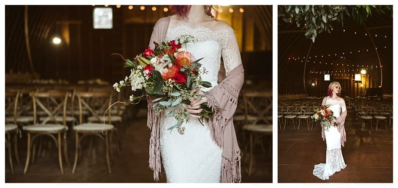 Premier snohomish & seattle wedding photographer | gsquared weddings photography a bride in a white lace gown and shawl holds a vibrant bouquet of flowers standing in a warmly lit rustic barn style venue near snohomish Empty wooden chairs line the background setting the scene for a seattle wedding engagement | serving snohomish seattle                   & beyond