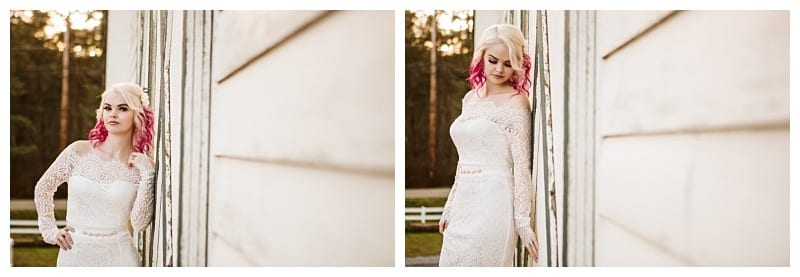 Premier snohomish & seattle wedding photographer | gsquared weddings photography a woman in a white lace off shoulder dress with pink tipped hair poses thoughtfully against a white wooden wall outdoors capturing the elegance of a snohomish seattle engagement Trees and a white fence frame the serene scene | serving snohomish seattle                   & beyond