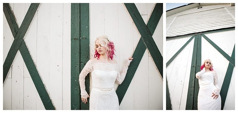 Premier snohomish & seattle wedding photographer | gsquared weddings photography a woman in a white lace dress with pink hair poses for a snohomish seattle engagement in front of large white barn doors with green wooden crosses standing with one hand on the door and looking off to the side while holding her hair | serving snohomish seattle                   & beyond