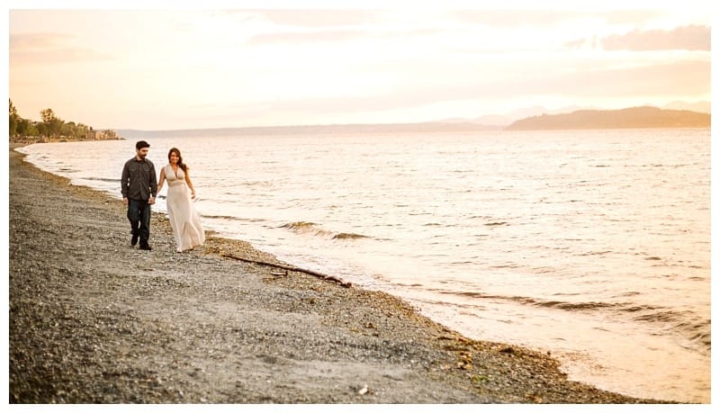 Premier snohomish & seattle wedding photographer | gsquared weddings photography a couple walks hand in hand along a pebbled beach at sunset near seattle the calm sea on their right and a golden sky in the backgrounda romantic scene perfect for a snohomish wedding engagement photo | serving snohomish seattle                   & beyond