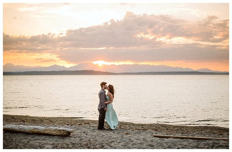 Alki beach engagement session seattle beach at sunset couple orange sunset pinks and teal