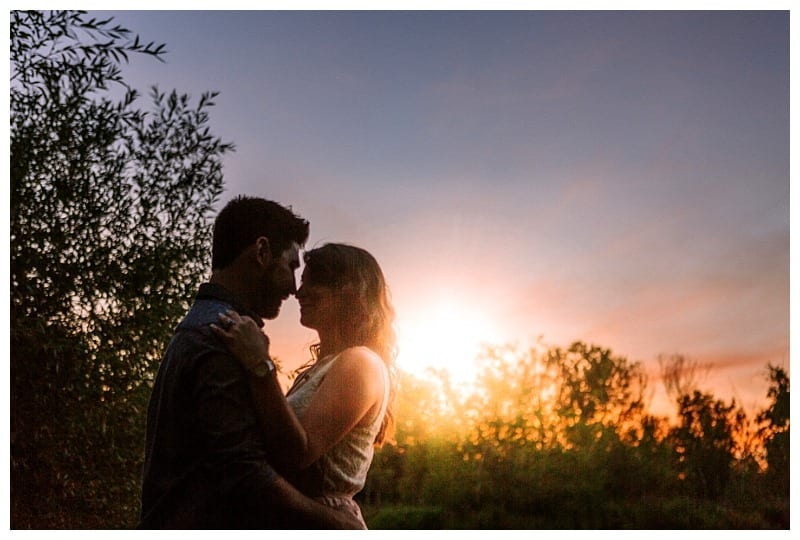 Premier snohomish & seattle wedding photographer | gsquared weddings photography a couple stands close together facing each other with foreheads touching silhouetted against a colorful snohomish sunset skyperfect for a romantic seattle wedding engagement Trees frame the magical moment in the background | serving snohomish seattle                   & beyond