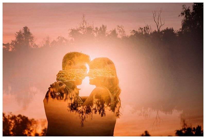 Premier snohomish & seattle wedding photographer | gsquared weddings photography a snohomish couple embraces and gazes into each others eyes at sunset with a double exposure effect blending their silhouettes with a serene lakeside landscape and glowing orange skyperfect for a seattle wedding engagement | serving snohomish seattle                   & beyond