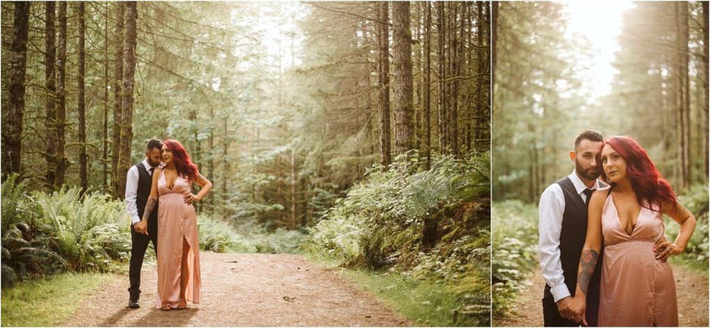 Premier snohomish & seattle wedding photographer | gsquared weddings photography a couple stands on a forest path near snohomish surrounded by tall trees and greenery The woman in a pink dress with red hair stands confidently while her partner gently leans incapturing the magic of a seattle wedding engagement | serving snohomish seattle                   & beyond