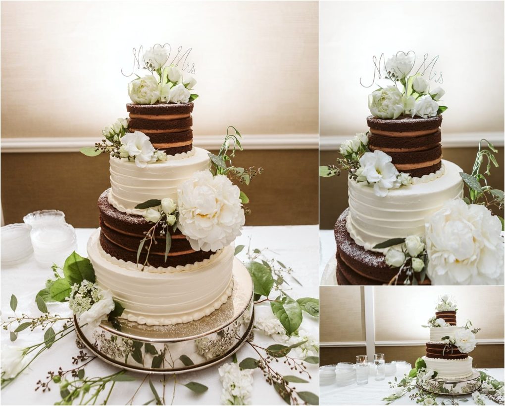 Premier snohomish & seattle wedding photographer | gsquared weddings photography a three tiered wedding cake with white and chocolate layers decorated with white flowers greenery and a mr & mrs topperperfect for a snohomish seattle weddingdisplayed on a white tablecloth with plates and utensils nearby | serving snohomish seattle                   & beyond