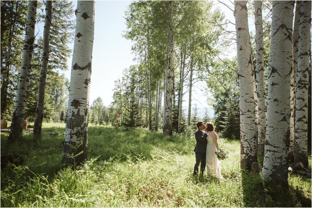 Premier snohomish & seattle wedding photographer | gsquared weddings photography a bride and groom stand embracing in a sunlit forest clearing near snohomish surrounded by tall birch trees and lush green grassa beautiful seattle wedding engagement scene with dappled sunlight filtering through the trees | serving snohomish seattle                   & beyond