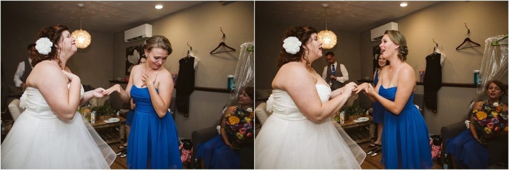 Premier snohomish & seattle wedding photographer | gsquared weddings photography two women one in a white wedding dress and the other in a blue bridesmaid dress laugh and hold hands in a warmly lit room sharing a joyful emotional moment before their snohomish seattle wedding ceremony | serving snohomish seattle                   & beyond