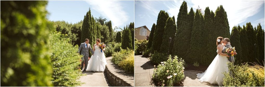 Premier snohomish & seattle wedding photographer | gsquared weddings photography two brides walk together and embrace outdoors on a sunny day in snohomish surrounded by tall green trees and lush plants both dressed in white wedding gowns and holding colorful bouquets | serving snohomish seattle                   & beyond