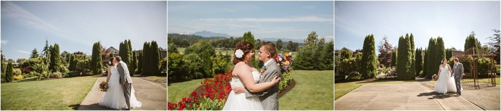 Premier snohomish & seattle wedding photographer | gsquared weddings photography a bride and groom embrace and share a kiss outdoors in a sunny snohomish garden with green lawns flowers and trees under a clear blue skycapturing the magic of their seattle wedding engagement | serving snohomish seattle                   & beyond