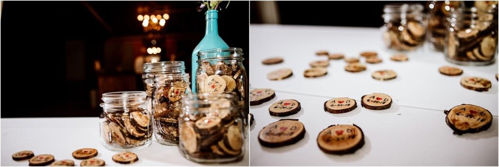 Premier snohomish & seattle wedding photographer | gsquared weddings photography several glass jars filled with small round decorated wooden tokens sit on a white tableperfect for a snohomish or seattle wedding engagementwith more tokens scattered around some featuring hand painted initials and a date | serving snohomish seattle                   & beyond