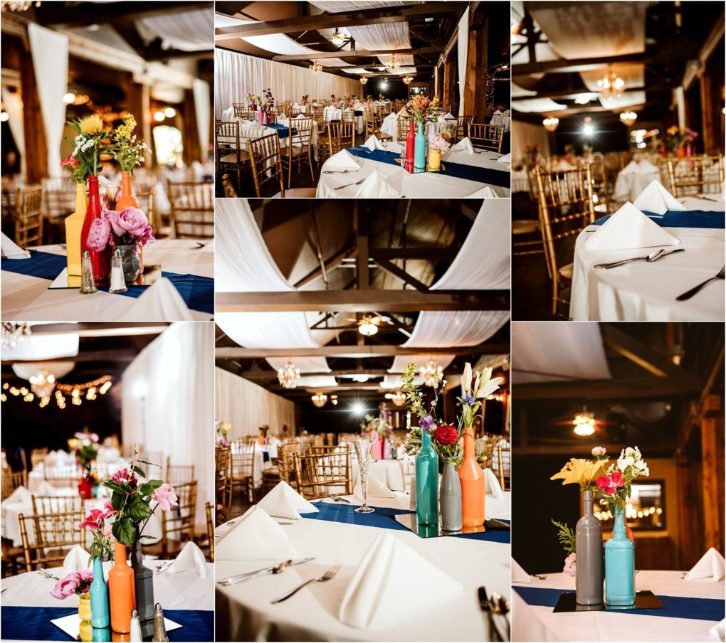 Premier snohomish & seattle wedding photographer | gsquared weddings photography a snohomish wedding reception hall with white drapes gold chairs navy blue table runners and napkins and centerpieces of colorful bottles filled with fresh flowers Warm lighting creates an inviting atmosphere for your seattle wedding or engagement celebration | serving snohomish seattle                   & beyond