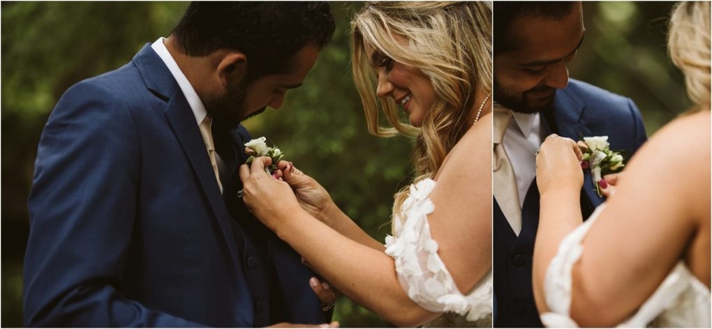 Premier snohomish & seattle wedding photographer | gsquared weddings photography a bride pins a white boutonnière onto the grooms blue suit as they smile and look down standing close together outdoors with greenery in the background during their snohomish seattle wedding | serving snohomish seattle                   & beyond