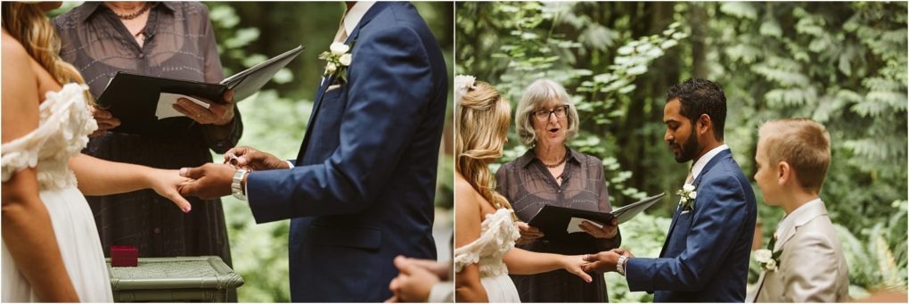 Premier snohomish & seattle wedding photographer | gsquared weddings photography at a snohomish wedding ceremony outdoors near seattle a couple exchanges rings as the officiant reads from a book the groom wears a blue suit and the bride a white dress framed by lush greenery in the background | serving snohomish seattle                   & beyond