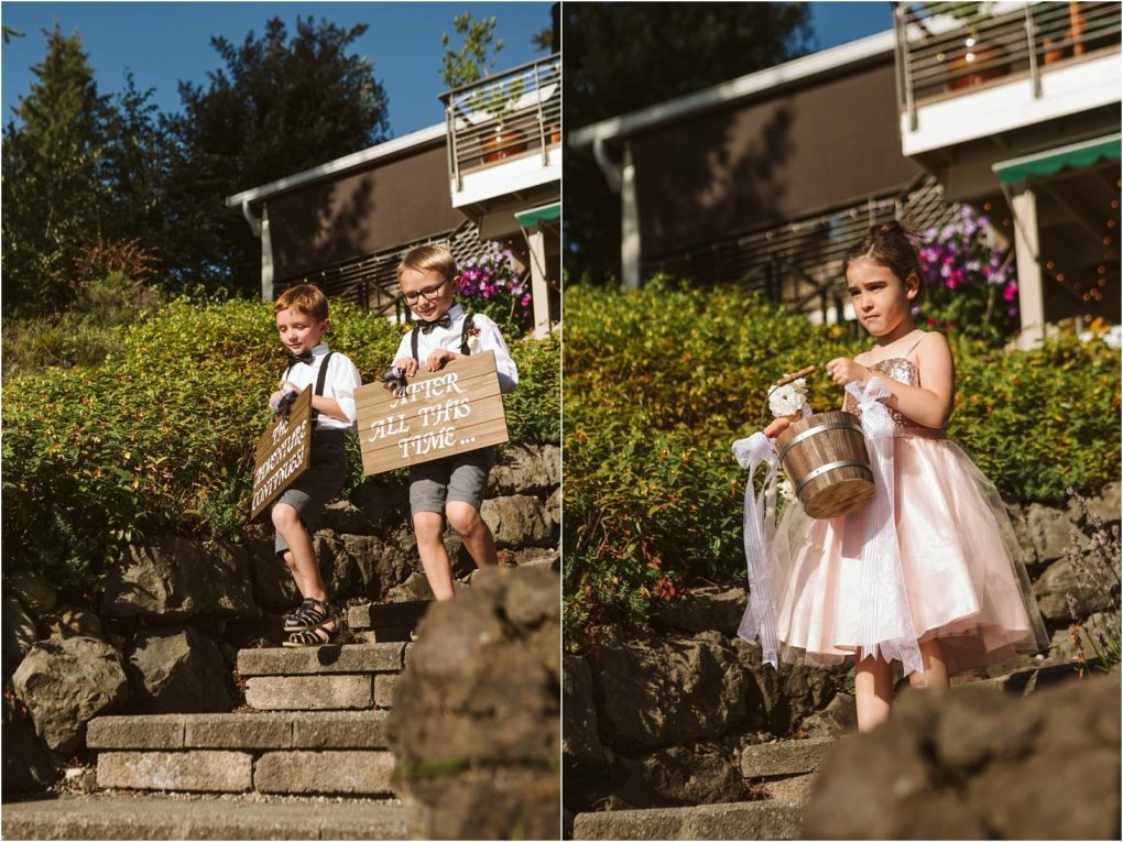 Premier snohomish & seattle wedding photographer | gsquared weddings photography two young boys in dress shirts and suspenders walk down stone steps holding a wooden sign Beside them a girl in a pink dress holds a basket with a teddy bearall outdoors at a charming snohomish seattle wedding venue | serving snohomish seattle                   & beyond