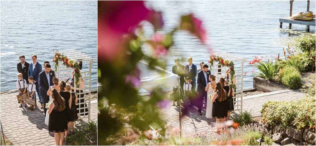 Premier snohomish & seattle wedding photographer | gsquared weddings photography a small snohomish outdoor wedding ceremony by a lake with the couple standing under a floral arch surrounded by a few people in formal attire Flowers and the lakeshore are visible as sunlight reflects off the water | serving snohomish seattle                   & beyond