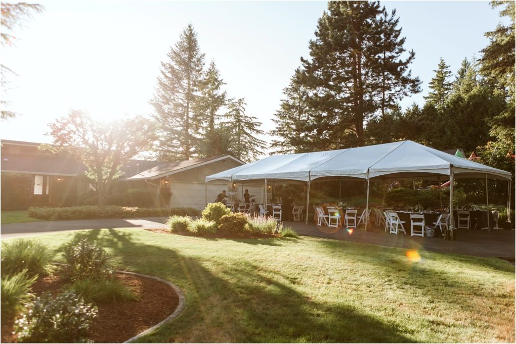 Premier snohomish & seattle wedding photographer | gsquared weddings photography a large white tent with tables and chairs set up underneath sits on a grassy lawn near a house surrounded by trees and landscaping with sunlight streaming throughperfect for a snohomish seattle wedding or engagement celebration | serving snohomish seattle                   & beyond
