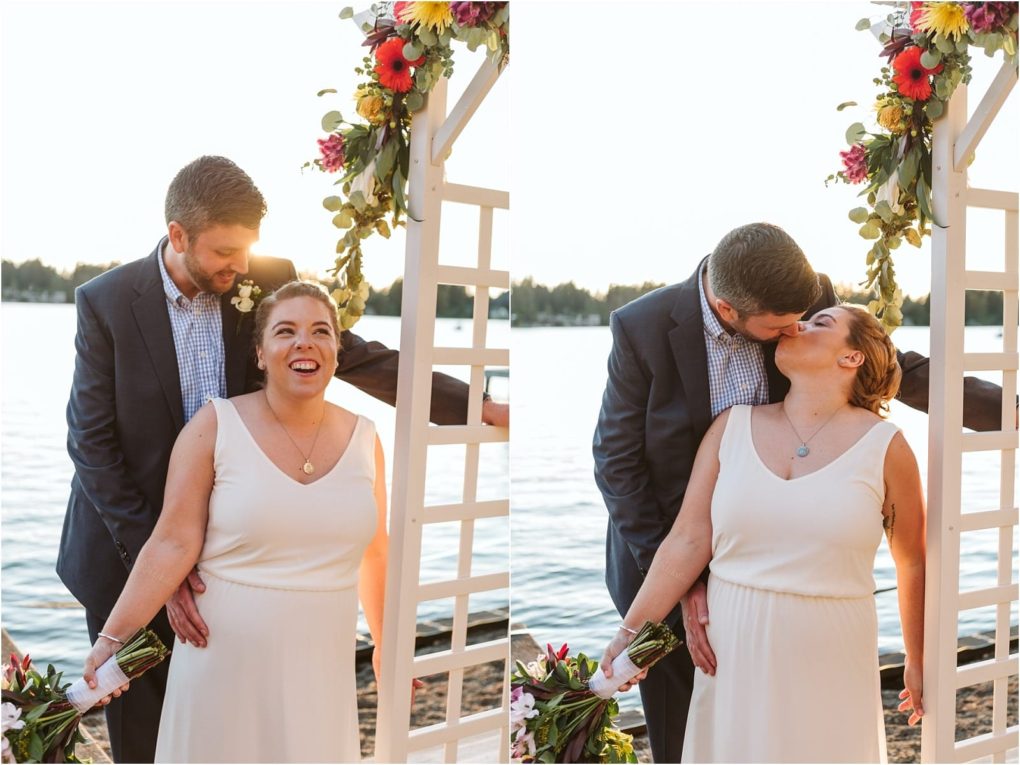 Premier snohomish & seattle wedding photographer | gsquared weddings photography a couple stands by a lake under a floral arch during their snohomish engagement The woman in a white dress smiles brightly as the man in a suit leans in to kiss her in the next frame they share a joyful celebratory kiss | serving snohomish seattle                   & beyond