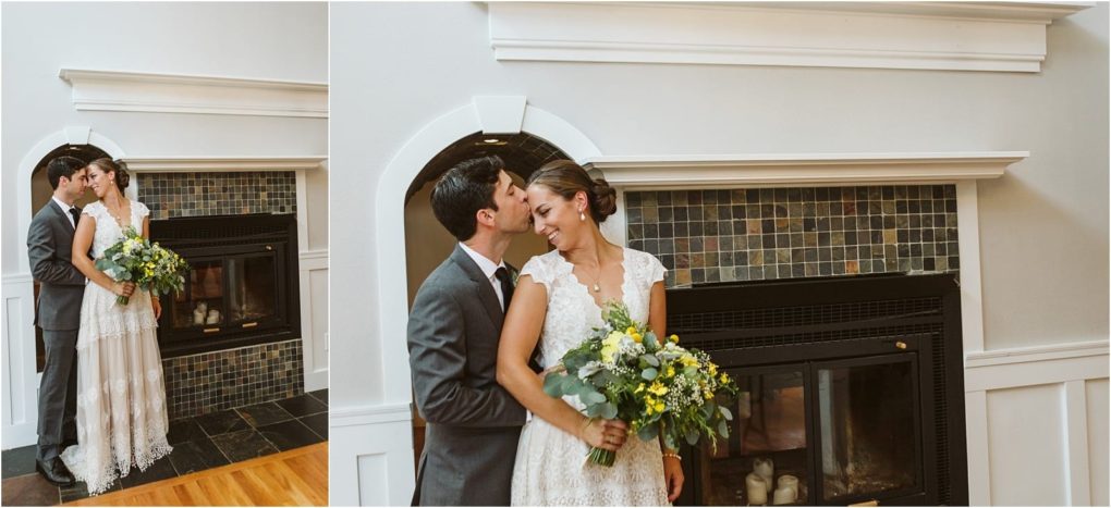Premier snohomish & seattle wedding photographer | gsquared weddings photography a newlywed couple stands in front of a tiled fireplace at their snohomish seattle wedding The groom in a gray suit kisses the brides forehead as she smiles holding a bouquet of greenery and yellow flowers | serving snohomish seattle                   & beyond