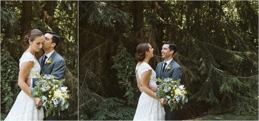 Premier snohomish & seattle wedding photographer | gsquared weddings photography a bride and groom stand together outdoors in snohomish in front of tall green trees embracing and smiling The bride holds a bouquet of yellow and white flowers with greenery Both wear formal wedding attire for their seattle wedding | serving snohomish seattle                   & beyond