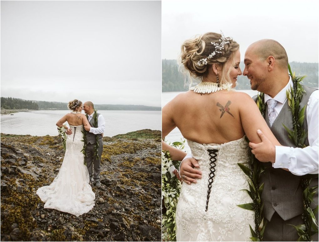 Premier snohomish & seattle wedding photographer | gsquared weddings photography a bride and groom embrace on a rocky shoreline near snohomish The brides white lace dress reveals a back tattoo while the groom wears a gray suit In this seattle wedding close up they smile closely surrounded by lush greenery | serving snohomish seattle                   & beyond