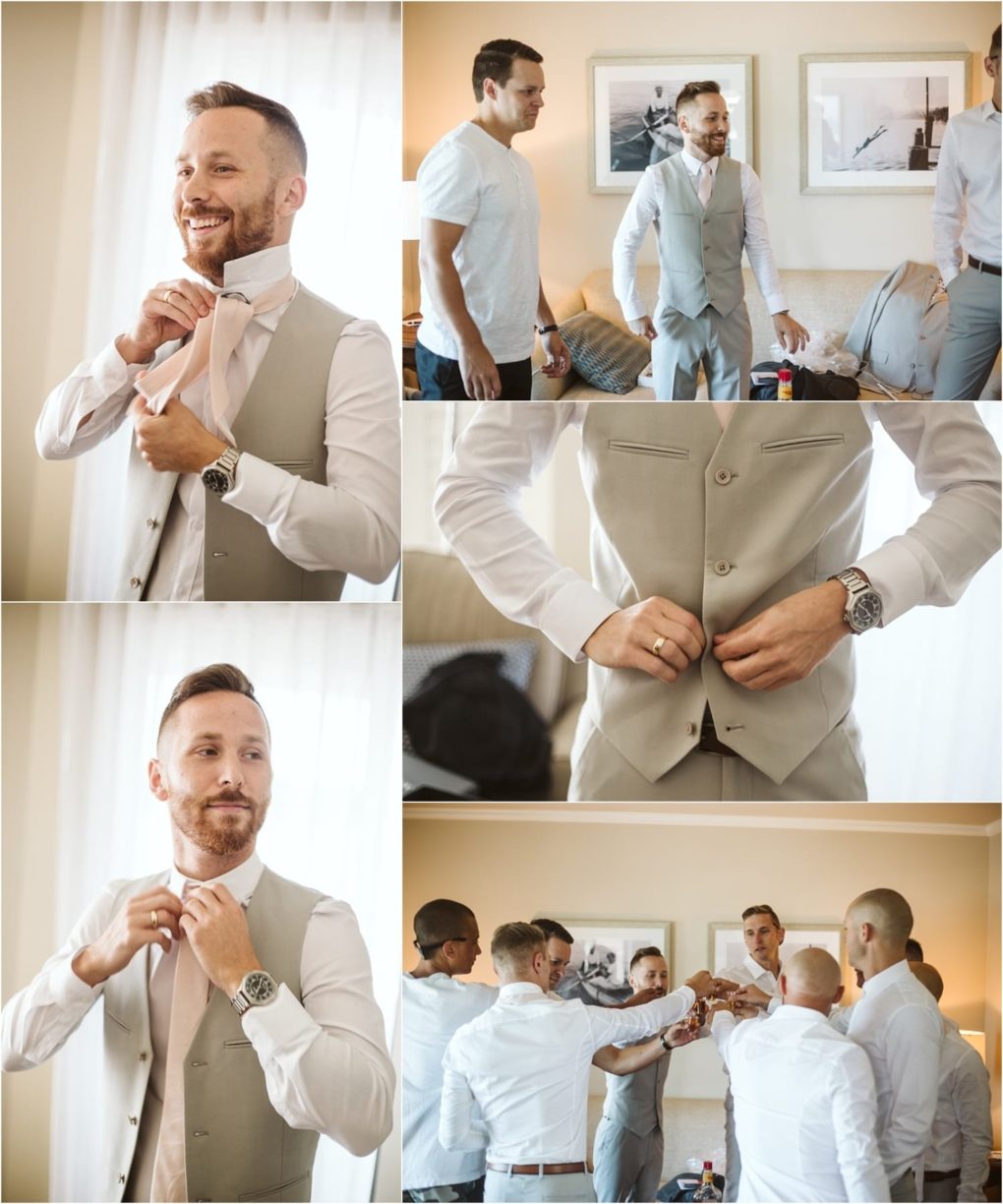 Premier snohomish & seattle wedding photographer | gsquared weddings photography a groom in a light gray suit gets ready with friends before his snohomish wedding He adjusts his tie buttons his vest and shares a toast with his groomsmen in a bright cozy room decorated with framed photos | serving snohomish seattle                   & beyond