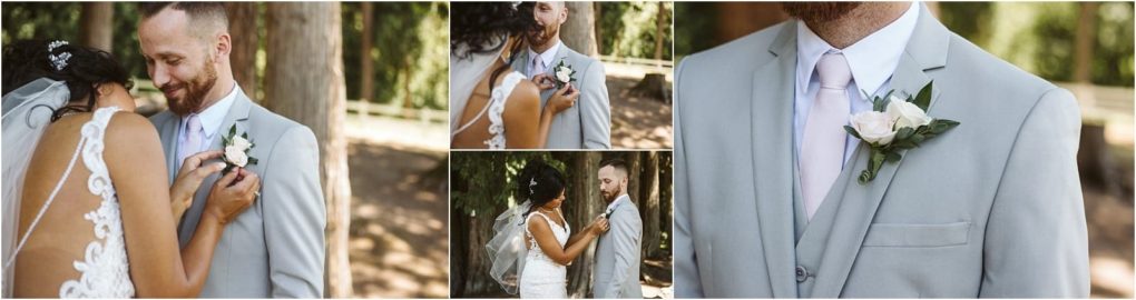 Premier snohomish & seattle wedding photographer | gsquared weddings photography a bride in a lace dress and veil pins a boutonniere on her groom in a light gray suit and pink tie they smile sharing a tender moment outdoors among trees at their romantic snohomish seattle wedding | serving snohomish seattle                   & beyond