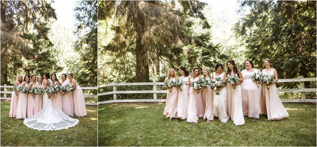 Premier snohomish & seattle wedding photographer | gsquared weddings photography a group of bridesmaids in blush pink dresses and a bride in a white gown stand together outdoors on grass at a beautiful snohomish seattle wedding with bouquets in hand smiling by a white fence and tall green trees | serving snohomish seattle                   & beyond