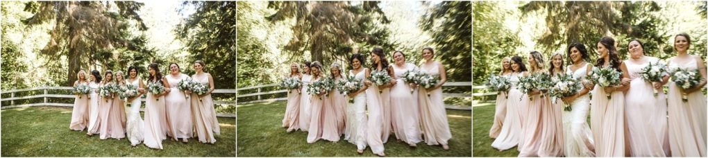 Premier snohomish & seattle wedding photographer | gsquared weddings photography a group of bridesmaids in light pink dresses and a bride in white walk together outdoors smiling and holding bouquets surrounded by green trees and a white fencecapturing the joy of a snohomish seattle wedding | serving snohomish seattle                   & beyond