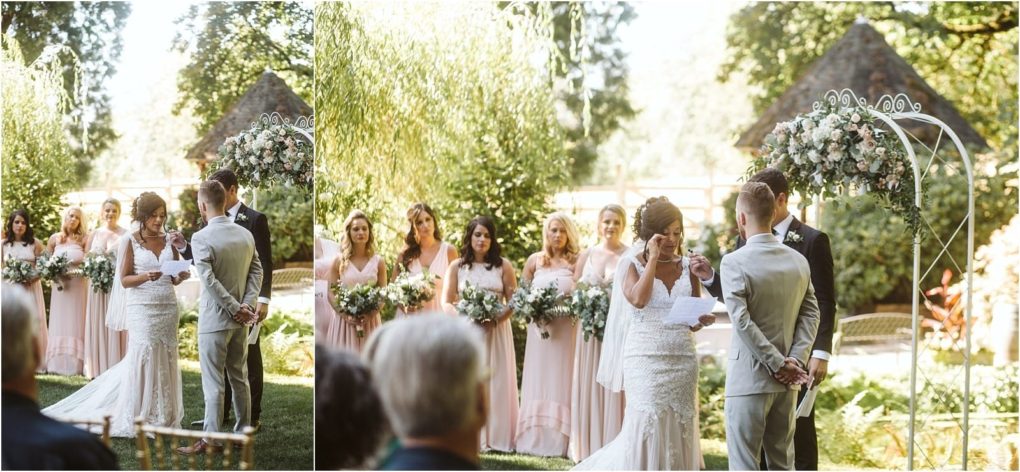 Premier snohomish & seattle wedding photographer | gsquared weddings photography a bride wipes her eyes while reading vows to the groom at a snohomish outdoor wedding ceremony surrounded by bridesmaids in light pink dresses holding bouquets Sunlight filters through greenery in the background | serving snohomish seattle                   & beyond