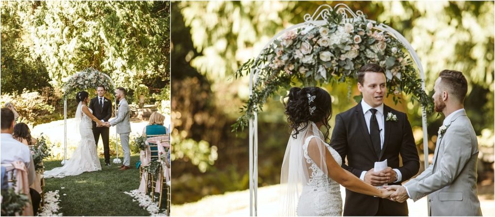 Premier snohomish & seattle wedding photographer | gsquared weddings photography a bride and groom stand under a floral arch outdoors in snohomish holding hands during their wedding ceremony with a man officiating Guests are seated as sunlight filters through the trees behind thema perfect seattle wedding moment | serving snohomish seattle                   & beyond