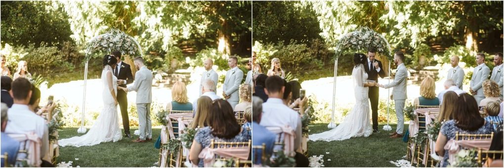 Premier snohomish & seattle wedding photographer | gsquared weddings photography a bride and groom exchange vows under a floral arch during a snohomish outdoor wedding ceremony surrounded by guests on both sides Lush greenery and sunlight fill the background creating a romantic seattle engagement atmosphere | serving snohomish seattle                   & beyond