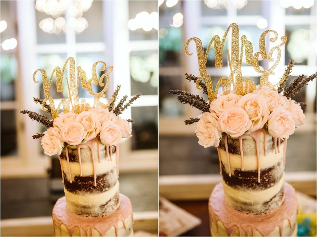 Premier snohomish & seattle wedding photographer | gsquared weddings photography a semi naked wedding cake topped with pink roses lavender sprigs and a gold glitter mrs & mrs signperfect for a dreamy snohomish or seattle wedding with blurred lights and windows setting the romantic background | serving snohomish seattle                   & beyond