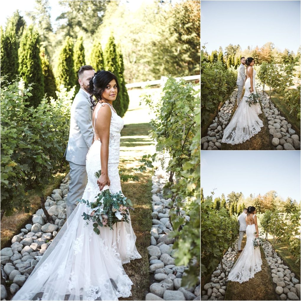 Premier snohomish & seattle wedding photographer | gsquared weddings photography a bride in a white lace gown holding a bouquet looks back while walking through a garden with her groom in a light suit Greenery and sunlight surround the couple in this romantic snohomish seattle wedding setting | serving snohomish seattle                   & beyond