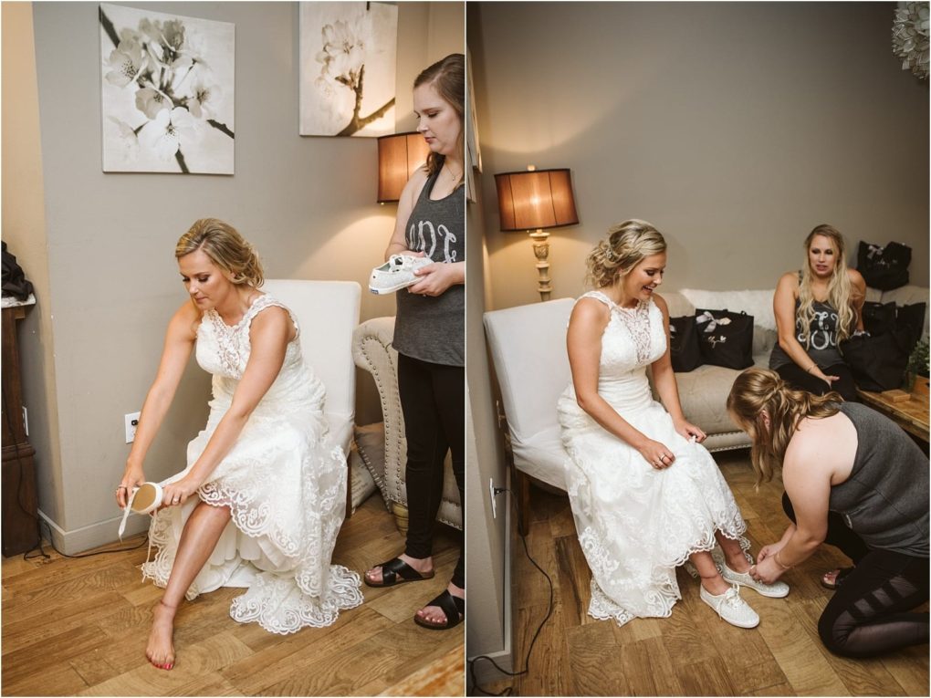 Premier snohomish & seattle wedding photographer | gsquared weddings photography a bride in a white dress sits on a chair while two women help her put on white sneakers replacing her dress shoes The cozy room perfect for a snohomish or seattle wedding has wooden floors neutral walls and a lamp beside her | serving snohomish seattle                   & beyond