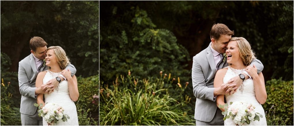 Premier snohomish & seattle wedding photographer | gsquared weddings photography a couple in wedding attire stands outdoors smiling and laughing together The groom in a light gray suit embraces the bride from behind as she holds a bouquet of white flowers Lush greenery fills this snohomish wedding scene | serving snohomish seattle                   & beyond