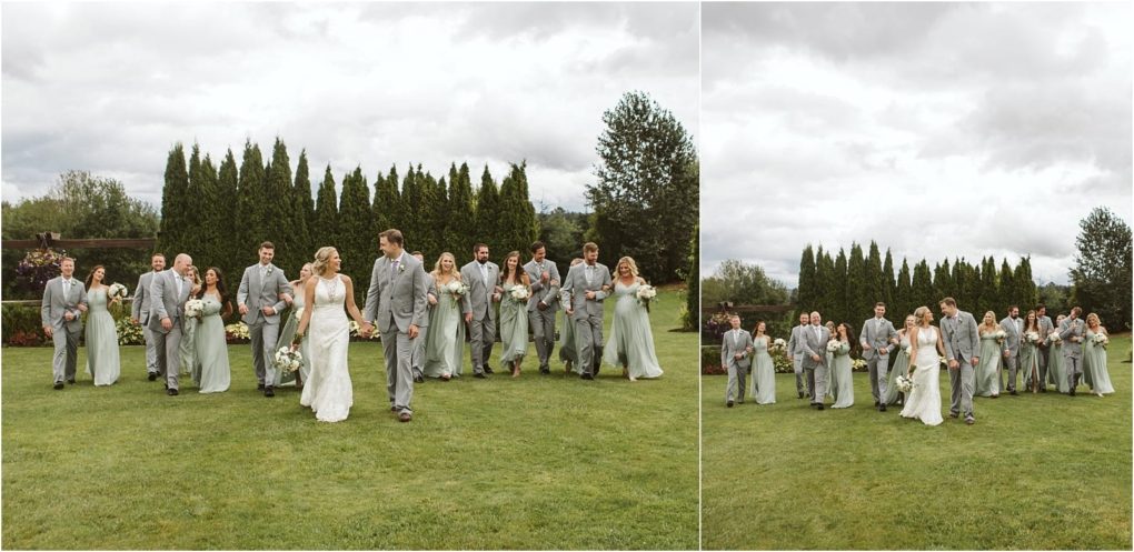 Premier snohomish & seattle wedding photographer | gsquared weddings photography a bride and groom walk hand in hand on a lawn at their snohomish seattle wedding surrounded by bridesmaids in light dresses and groomsmen in gray suits all smiling and chatting under a cloudy sky with tall trees in the background | serving snohomish seattle                   & beyond