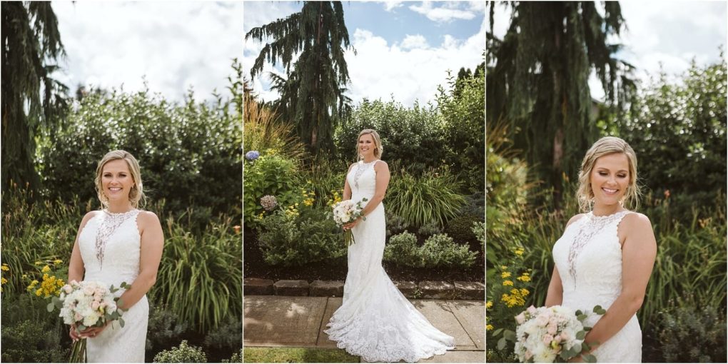 Premier snohomish & seattle wedding photographer | gsquared weddings photography a bride in a white lace gown holds a bouquet and poses outdoors in a lush snohomish garden filled with greenery trees and flowersperfect for a seattle wedding engagement under a partly cloudy sky | serving snohomish seattle                   & beyond