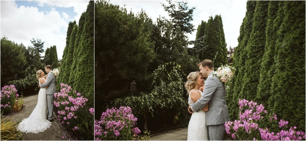 Premier snohomish & seattle wedding photographer | gsquared weddings photography a bride and groom embrace and smile at each other outdoors on a cloudy day surrounded by green trees and pink flowers along a pathwaycapturing the romance of a snohomish seattle wedding | serving snohomish seattle                   & beyond