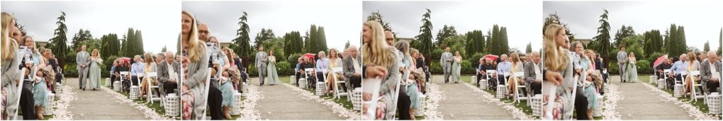 Premier snohomish & seattle wedding photographer | gsquared weddings photography a joyful snohomish wedding ceremony outdoors with guests seated in rows along a petal lined aisle Some hold umbrellas adding charm to the relaxed atmosphere Lush greenery and trees create a stunning backdrop for this beautiful seattle celebration | serving snohomish seattle                   & beyond