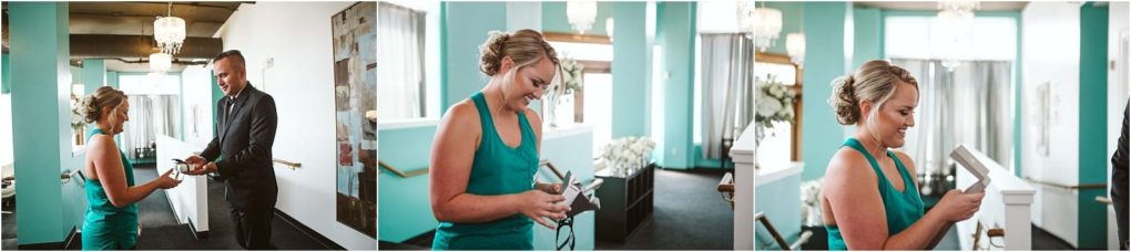 Premier snohomish & seattle wedding photographer | gsquared weddings photography a woman in a teal dress receives a small box from a man in a suit during a snohomish seattle engagement then happily opens it and looks inside while standing in a bright room with teal walls and chandeliers | serving snohomish seattle                   & beyond